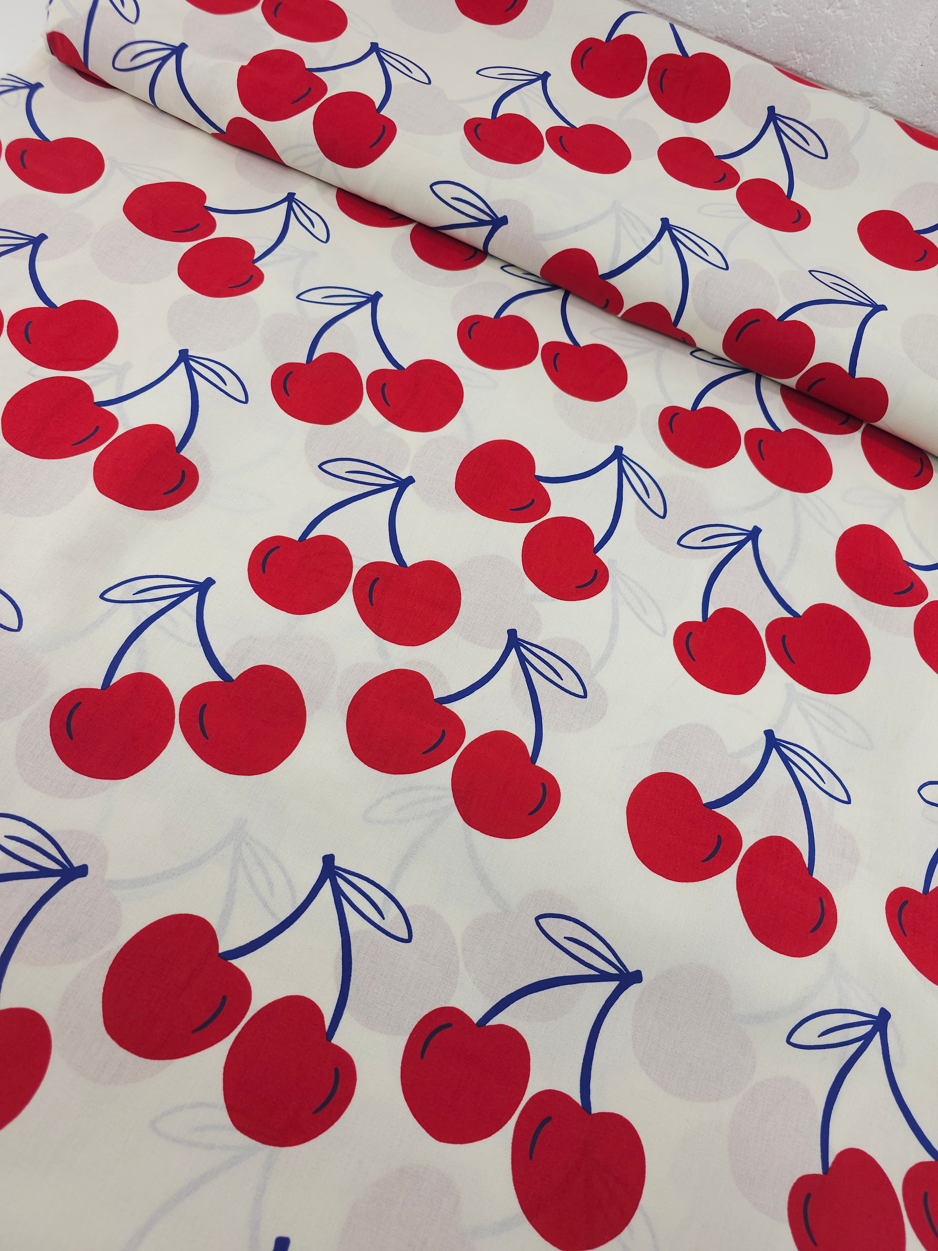 Ivory/Red Large Cherries Coated Cotton 60"