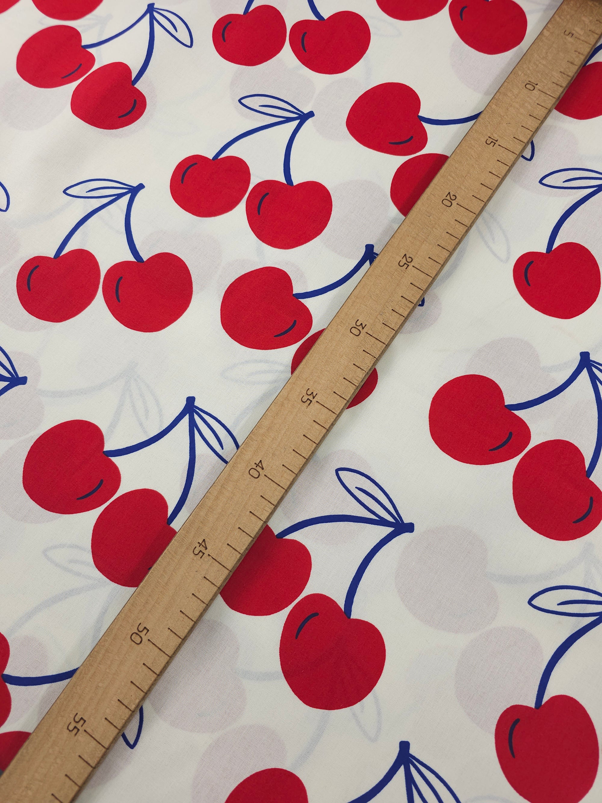 Ivory/Red Large Cherries Coated Cotton 60"